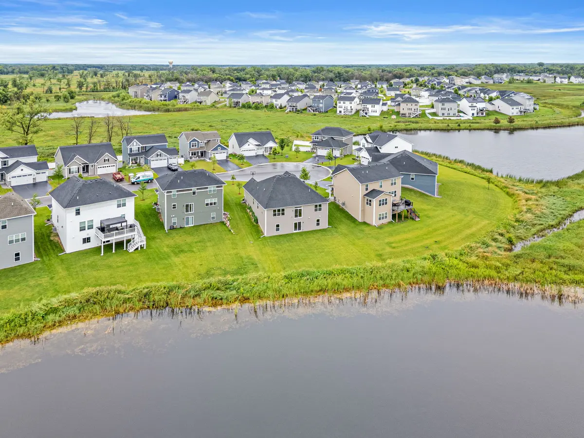 Aerial view of a Blaine lakeside neighborhood with rows of homes framing a pond