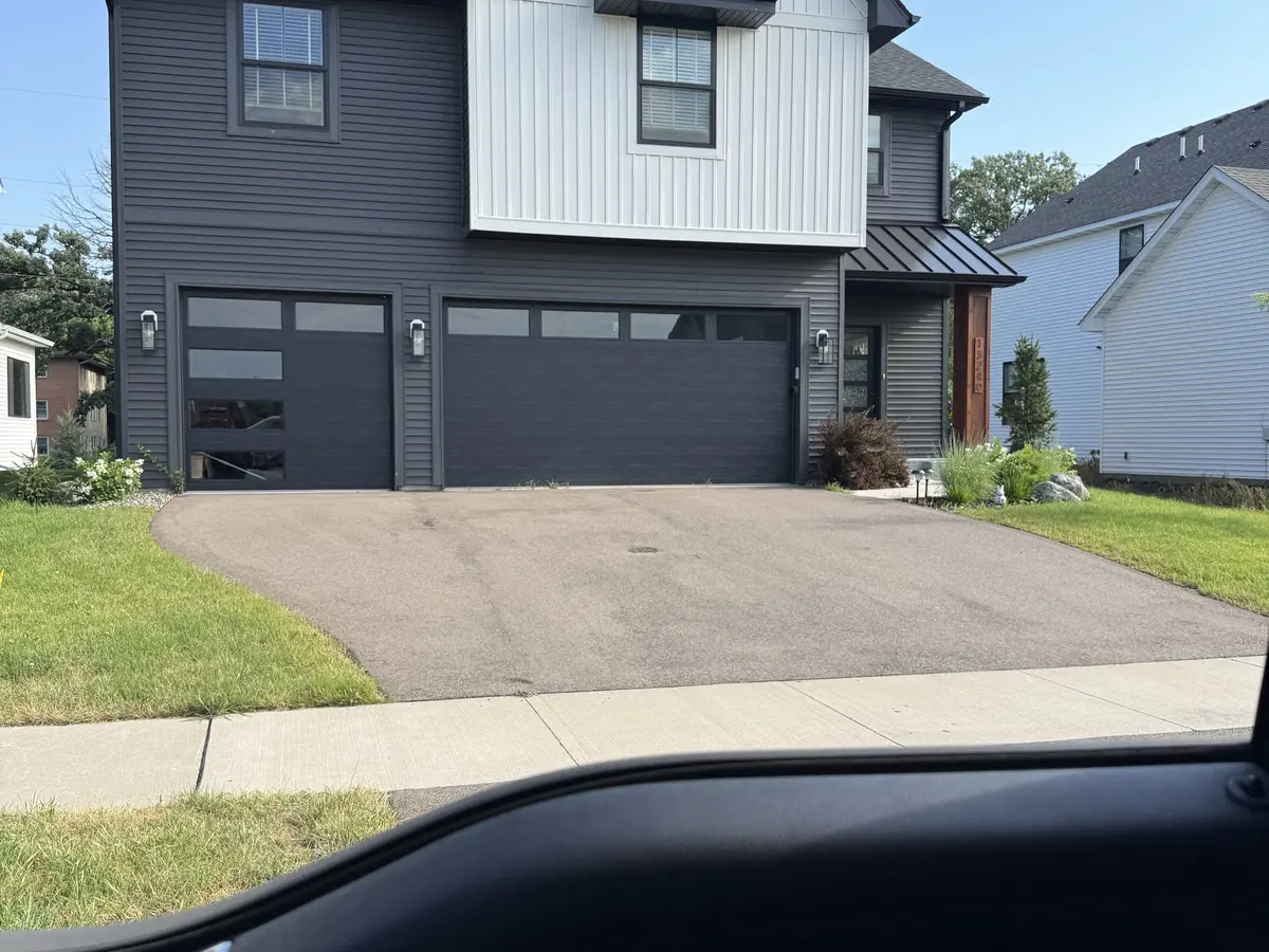 Modern two-story home with black and white board-and-batten exterior in newer Blaine