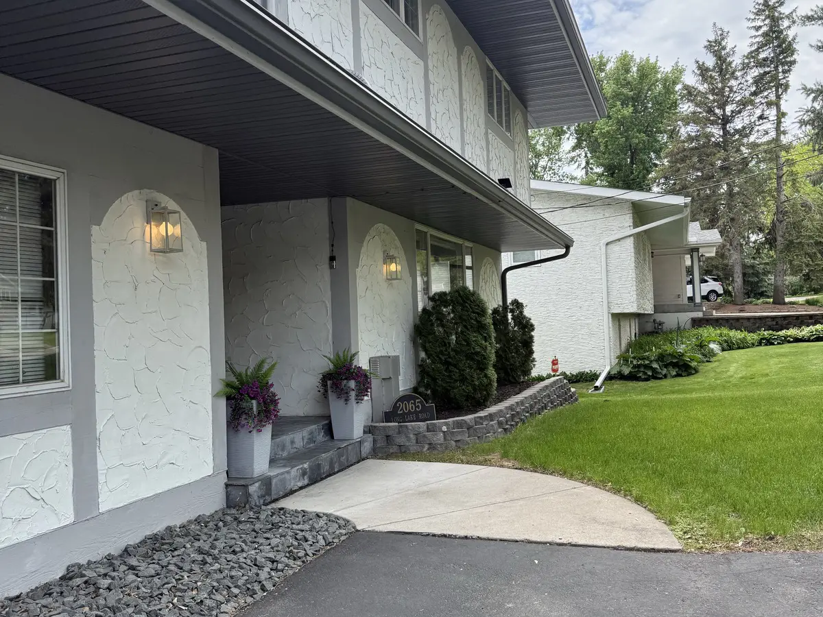 White split-level home on an established, tree-lined lot in older Blaine