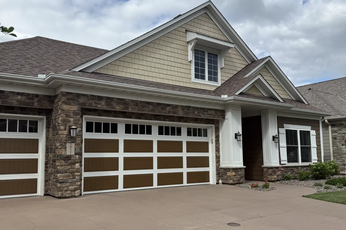 Craftsman-style home with stone detail and a wide driveway in The Lakes, Blaine